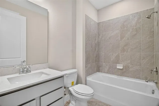 a bathroom with a sink a toilet and a bathtub