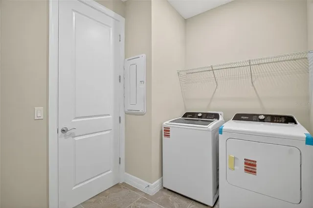 a view of washer and dryer with kitchen in the background