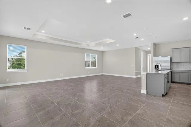 a view of a kitchen with a sink and a refrigerator