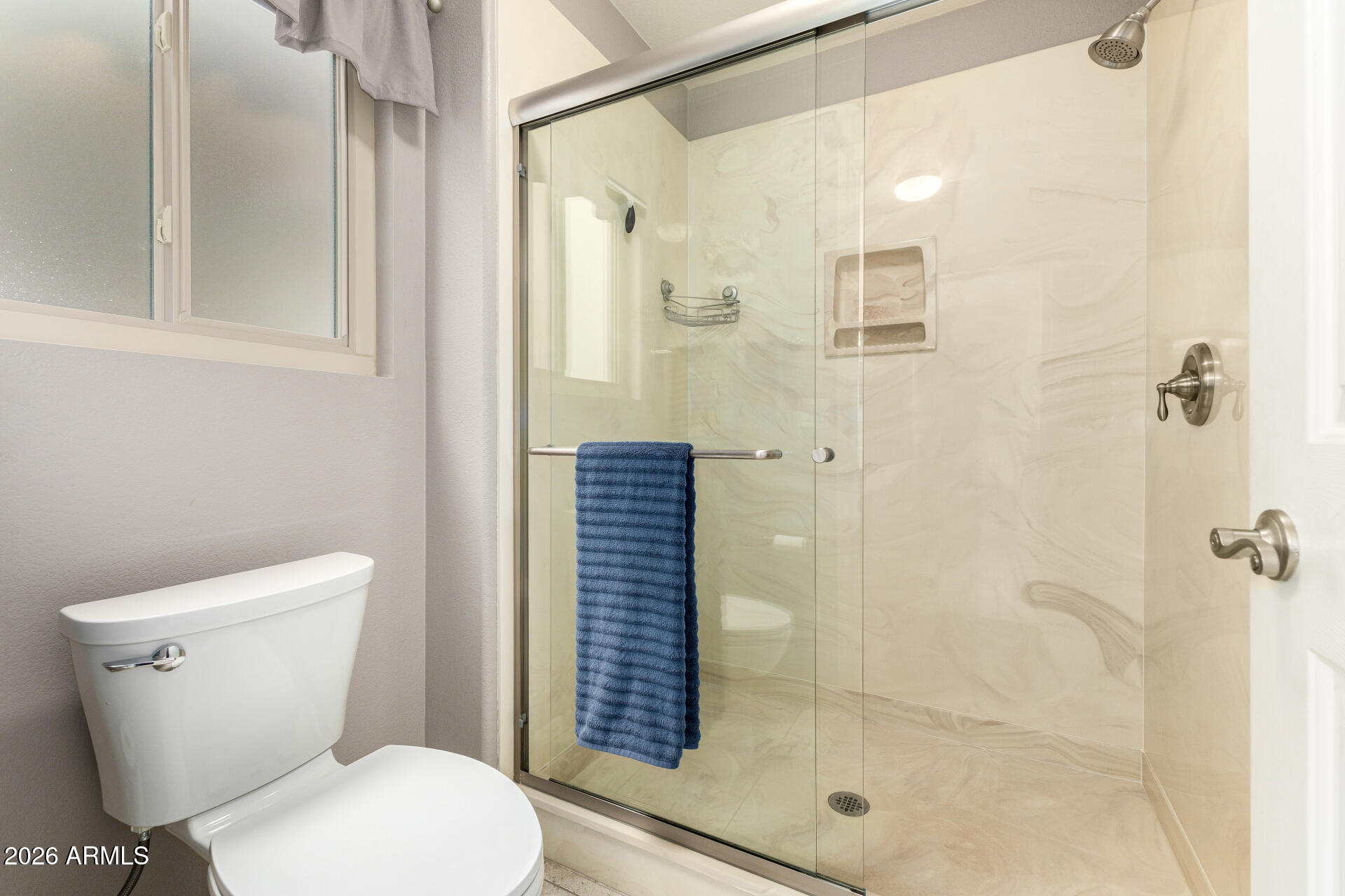 8302 West Marco Polo Road Peoria, AZ 85382 - Photo 19 of 30 a white toilet sitting next to a bathroom sink