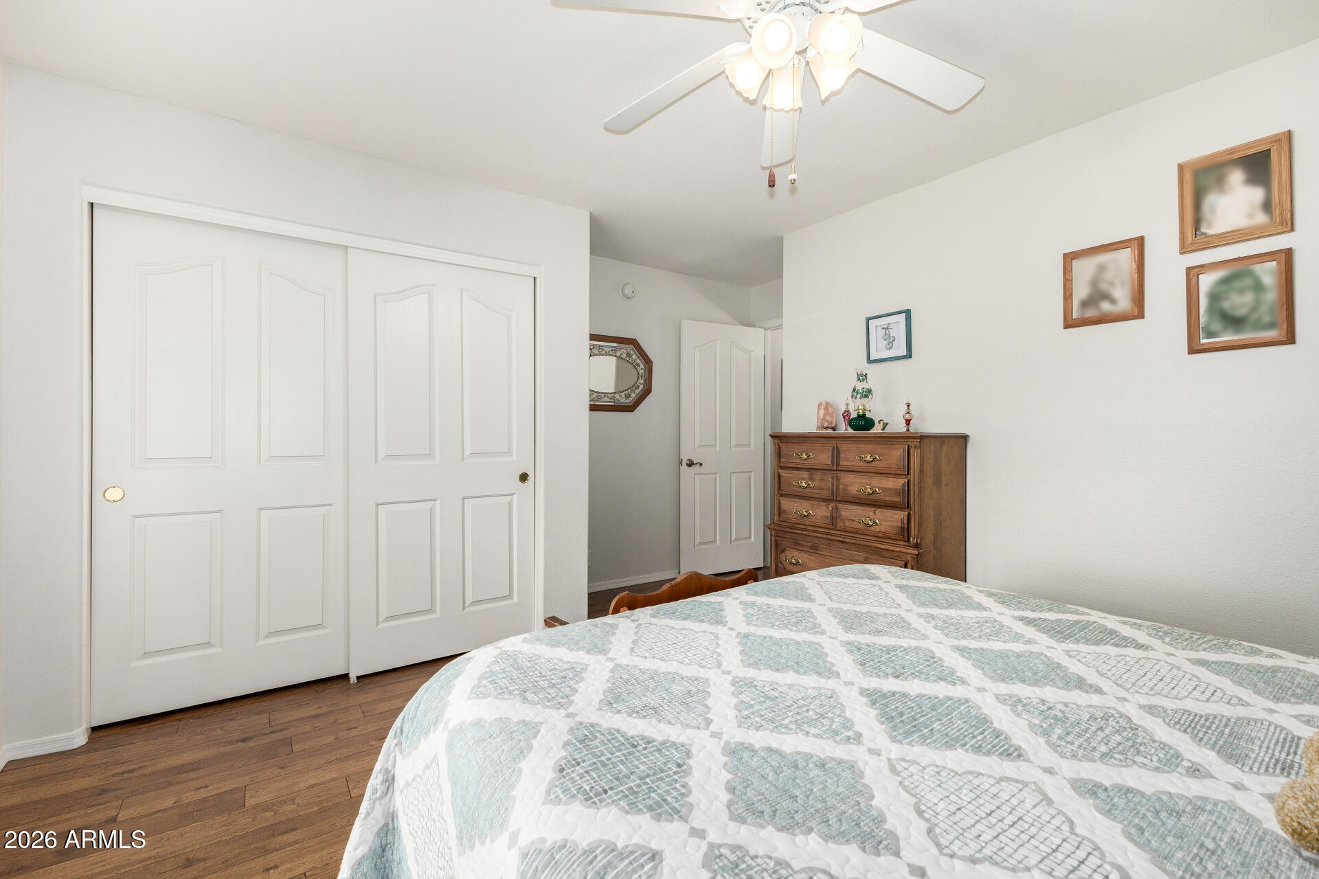8302 West Marco Polo Road Peoria, AZ 85382 - Photo 22 of 30 a bedroom with a large bed and a chandelier