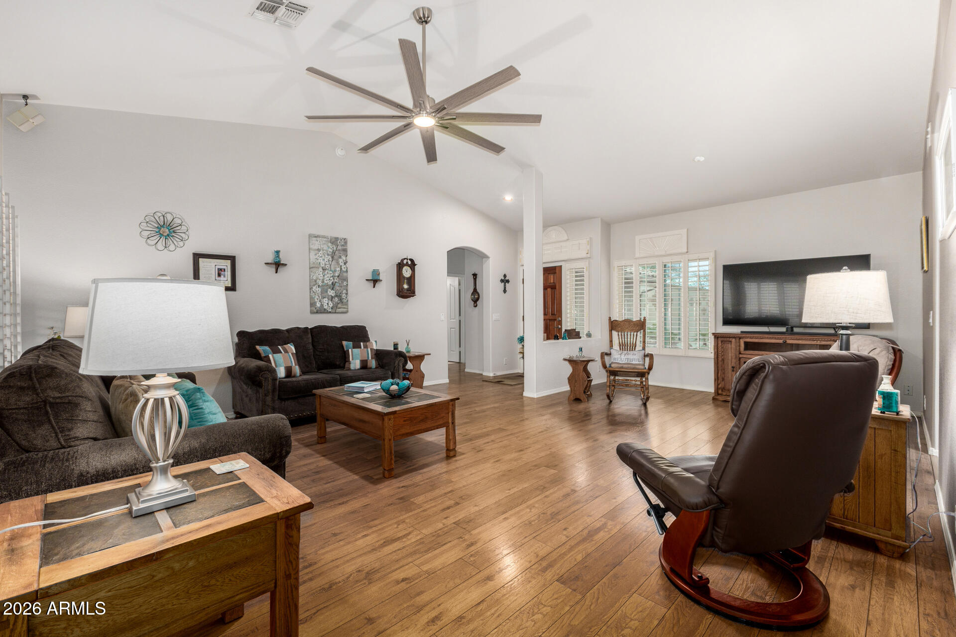 8302 West Marco Polo Road Peoria, AZ 85382 - Photo 6 of 30 a living room with furniture a ceiling fan and a window