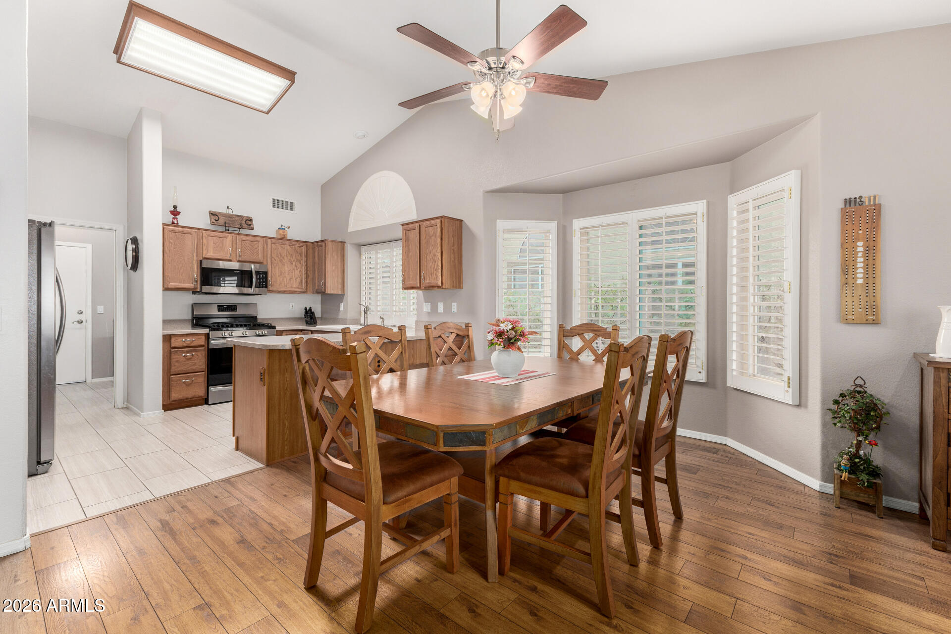 8302 West Marco Polo Road Peoria, AZ 85382 - Photo 7 of 30 a view of a dining room with furniture window and wooden floor