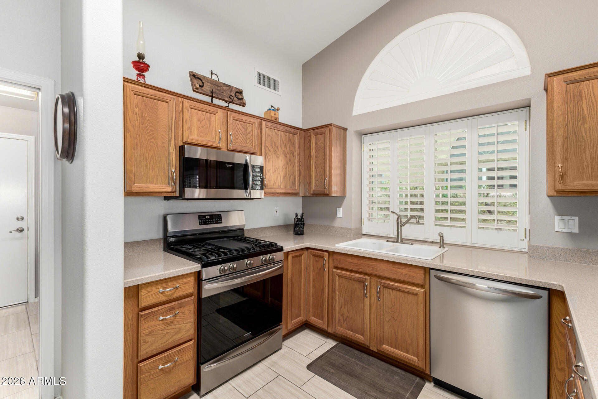 8302 West Marco Polo Road Peoria, AZ 85382 - Photo 9 of 30 a kitchen with granite countertop a sink stainless steel appliances and cabinets