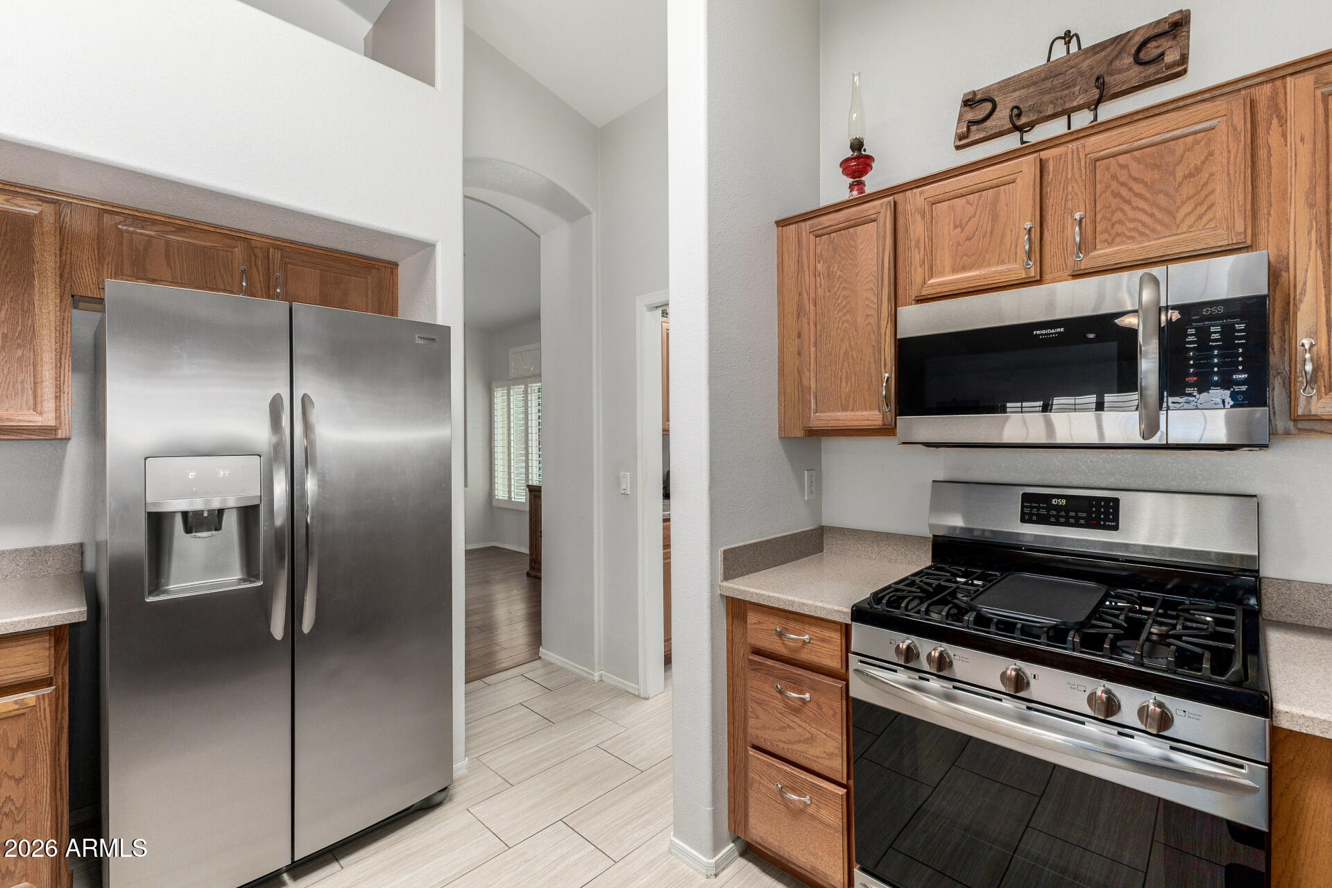 8302 West Marco Polo Road Peoria, AZ 85382 - Photo 10 of 30 a kitchen with stainless steel appliances granite countertop a stove and a refrigerator