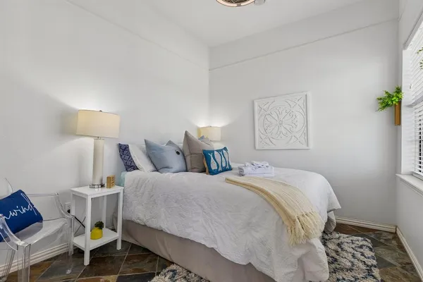 a bed room with a bed and a lamp