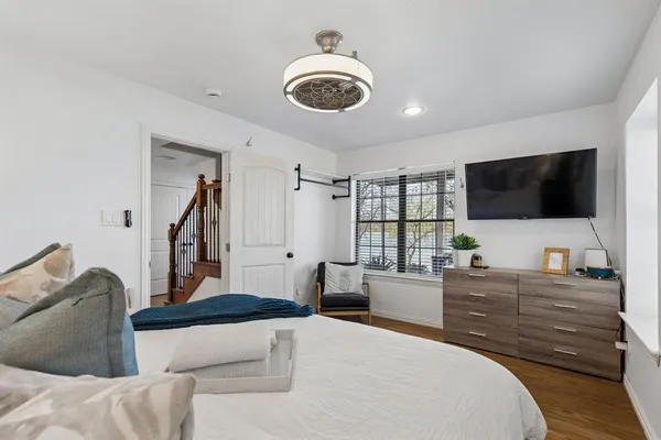 a bedroom with a bed and a flat screen tv