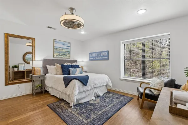 a bed room with couch and a window