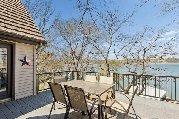 a view of a chairs and table on the deck