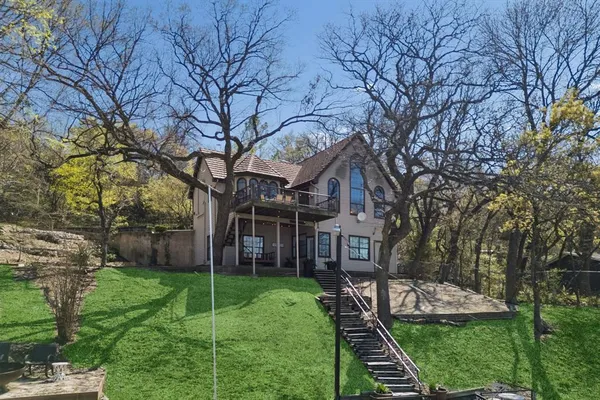 a view of a house with backyard and a tree
