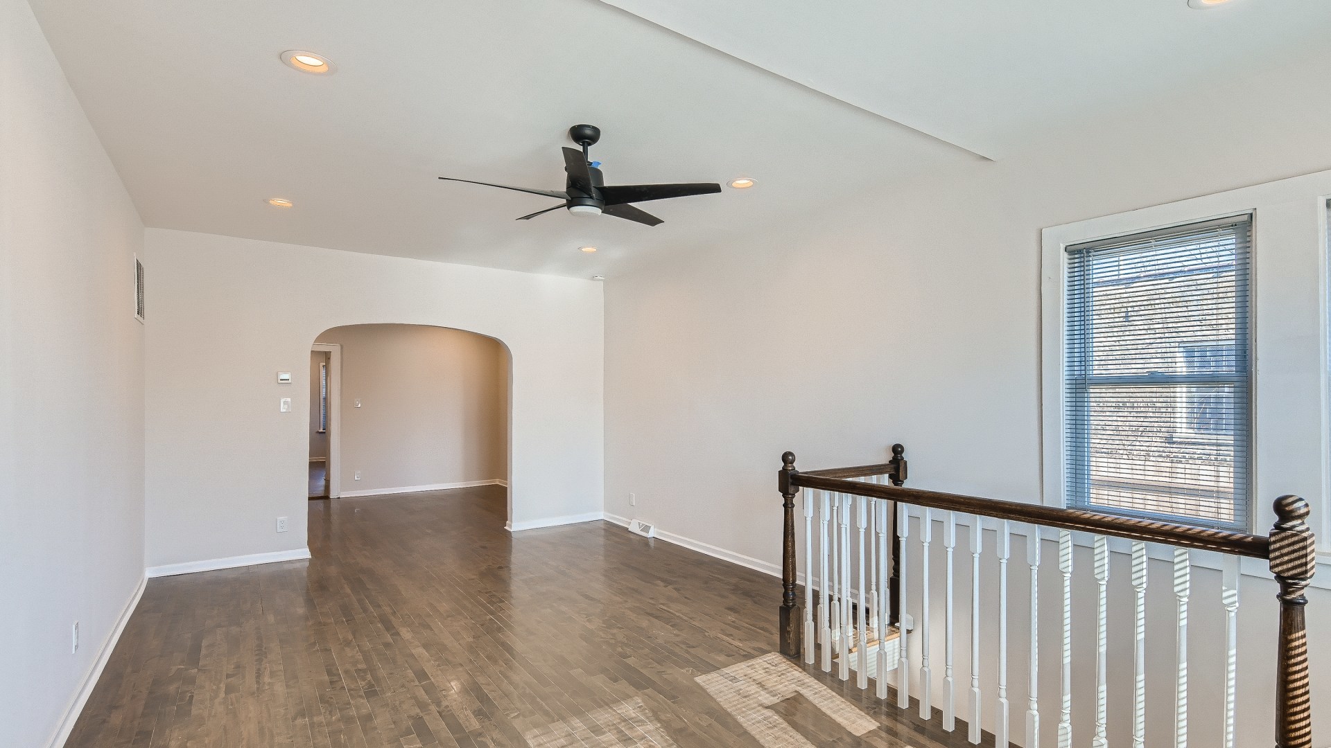 506 Pulaski Road Calumet City, IL 60409 - Photo 3 of 30 a view of a hallway with wooden floor and a ceiling fan