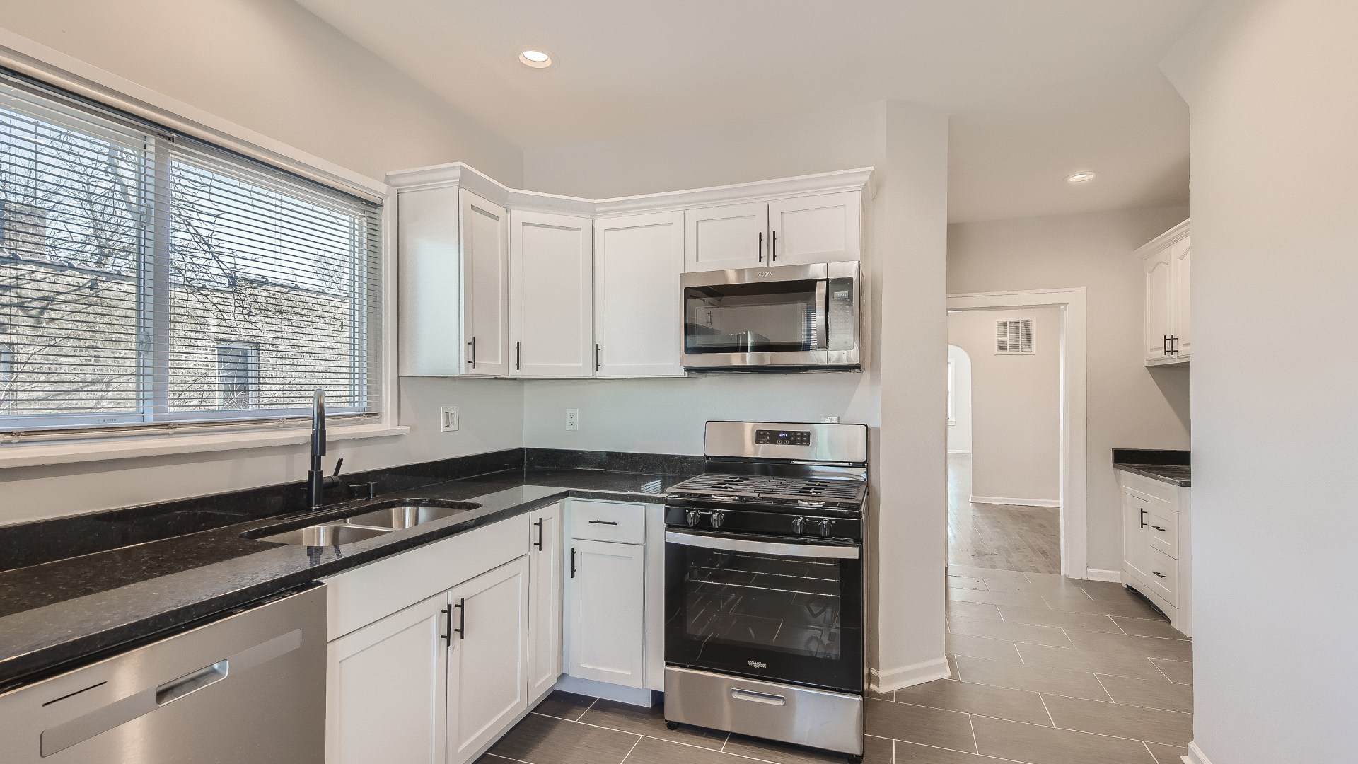 506 Pulaski Road Calumet City, IL 60409 - Photo 8 of 30 a kitchen with stainless steel appliances a sink a stove a microwave and cabinets