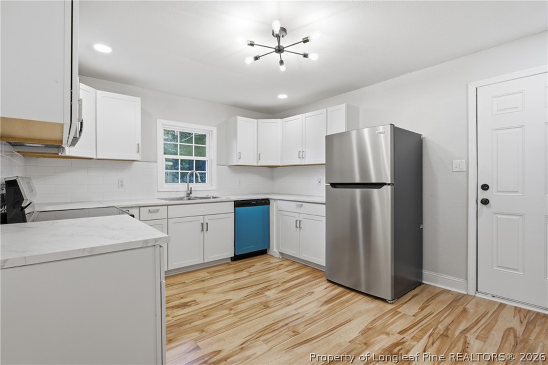 190 Payton Place Road Lumber Bridge, NC 28357 - Photo 12 of 43 a kitchen with stainless steel appliances a refrigerator sink and cabinets