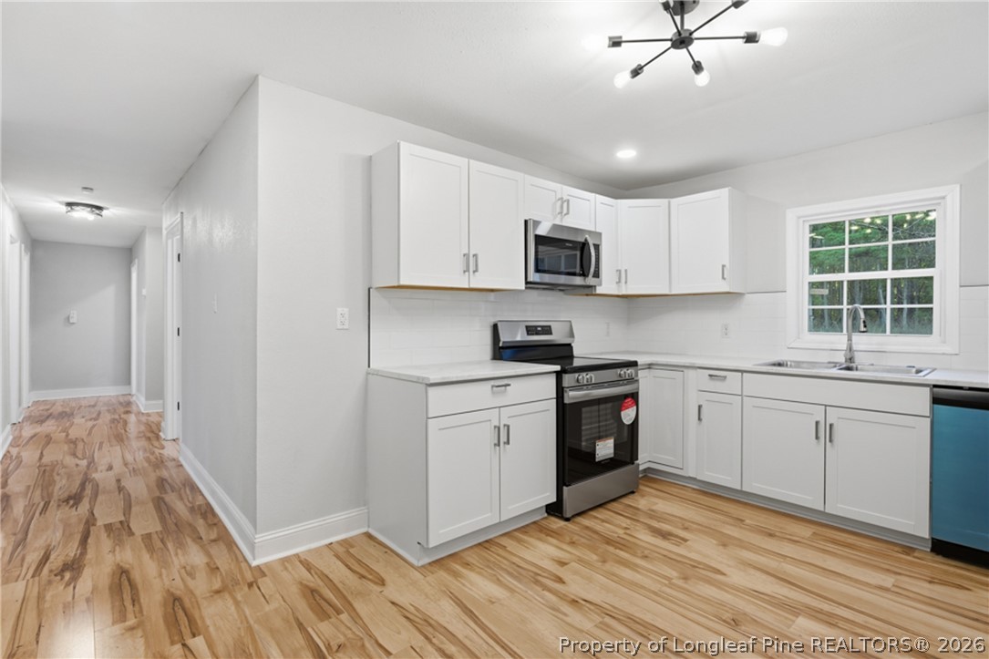 190 Payton Place Road Lumber Bridge, NC 28357 - Photo 15 of 43 a kitchen with cabinets stainless steel appliances a sink and a window