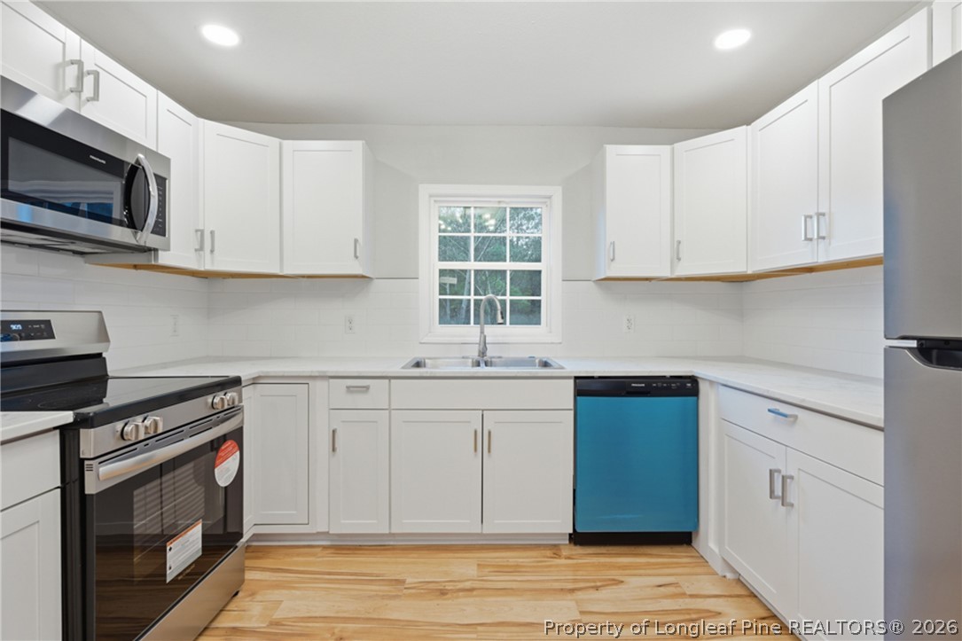 190 Payton Place Road Lumber Bridge, NC 28357 - Photo 16 of 43 a kitchen with stainless steel appliances granite countertop a stove a sink and a microwave