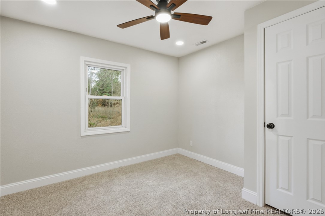 190 Payton Place Road Lumber Bridge, NC 28357 - Photo 19 of 43 an empty room with ceiling fan and window