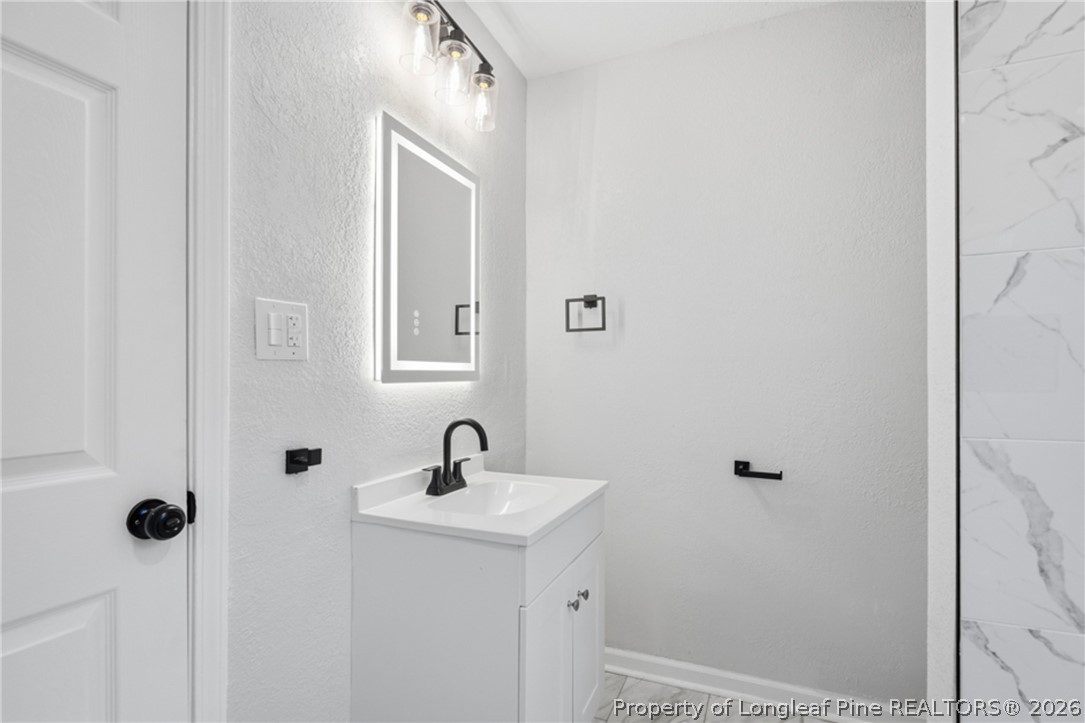 190 Payton Place Road Lumber Bridge, NC 28357 - Photo 24 of 43 a bathroom with a sink and mirror