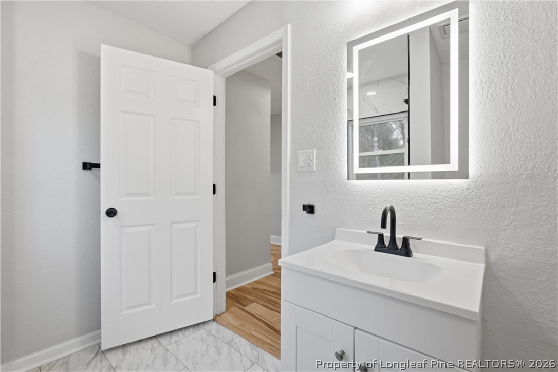190 Payton Place Road Lumber Bridge, NC 28357 - Photo 26 of 43 a bathroom with a sink and mirror