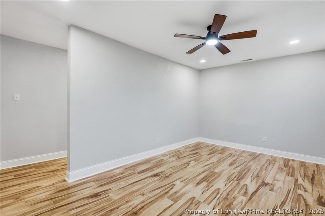 190 Payton Place Road Lumber Bridge, NC 28357 - Photo 8 of 43 a view of an empty room with wooden floor and a ceiling fan