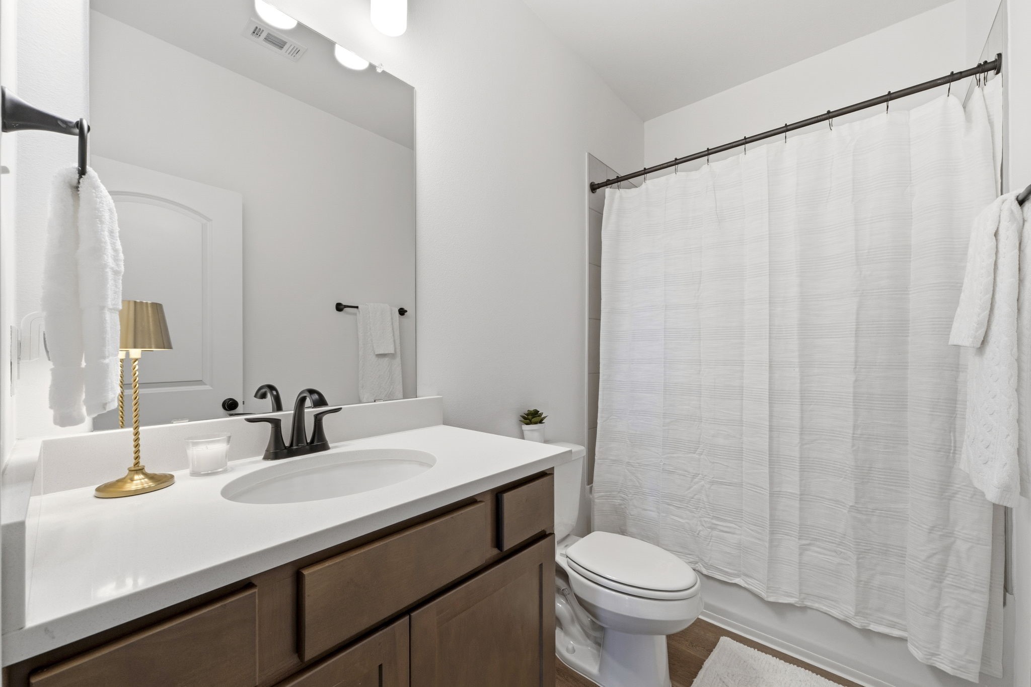 10934 Bonfire Trail Beasley, TX 77417 - Photo 21 of 32 Full guest bath with quartz countertops, modern fixtures, and a tiled tub/shower combination.