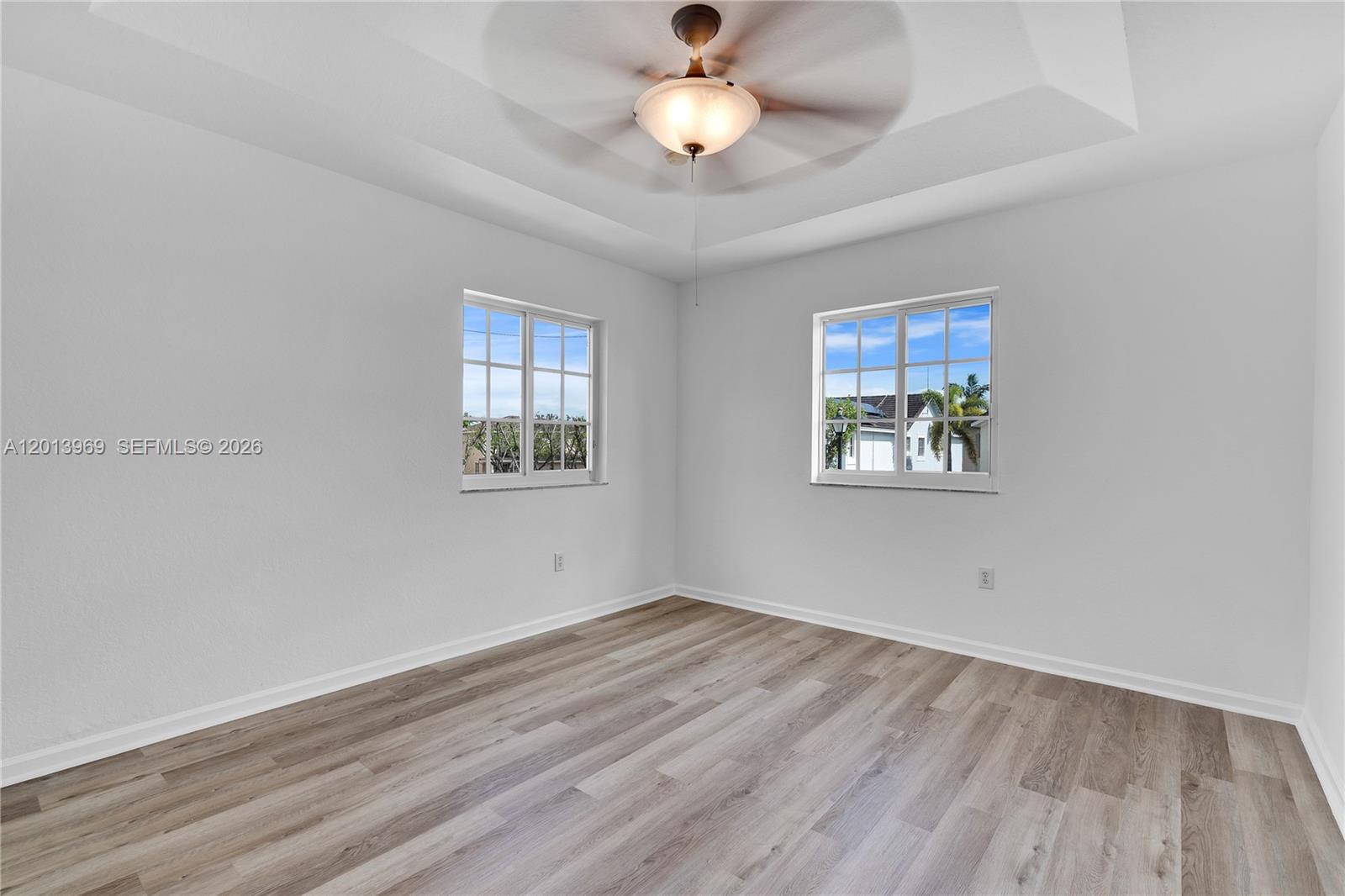 14044 Southwest 273rd Lane, Unit 14044 Homestead, FL 33032 - Photo 19 of 44 wooden floor in an empty room with a window