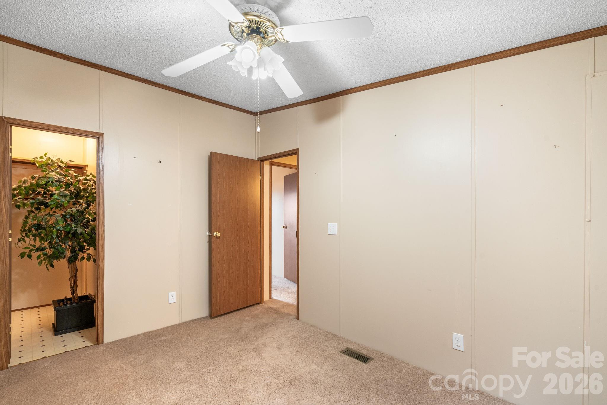 210 Ledbetter Lane Franklin, NC 28734 - Photo 21 of 32 an empty room with a chandelier fan and closet
