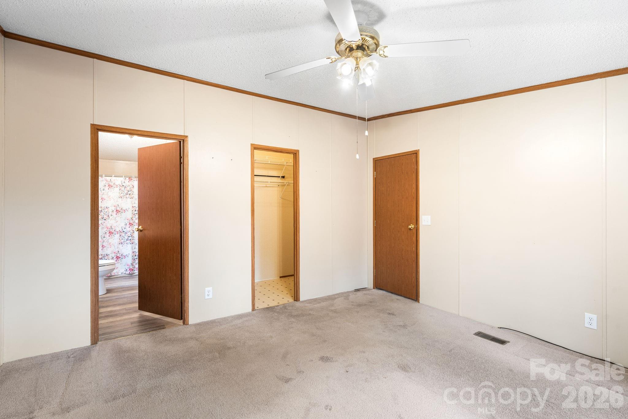 210 Ledbetter Lane Franklin, NC 28734 - Photo 26 of 32 an empty room with closet and a chandelier fan