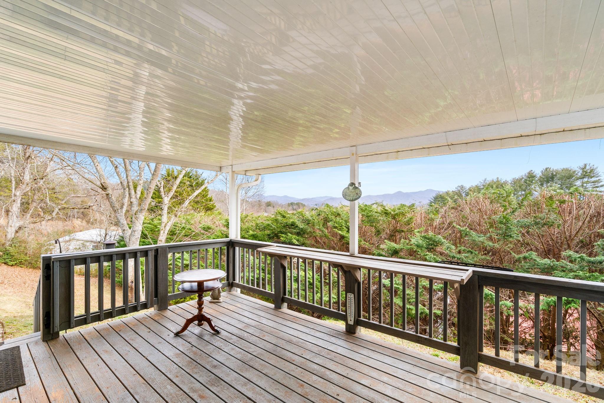 210 Ledbetter Lane Franklin, NC 28734 - Photo 4 of 32 a view of a balcony with wooden floor and fence