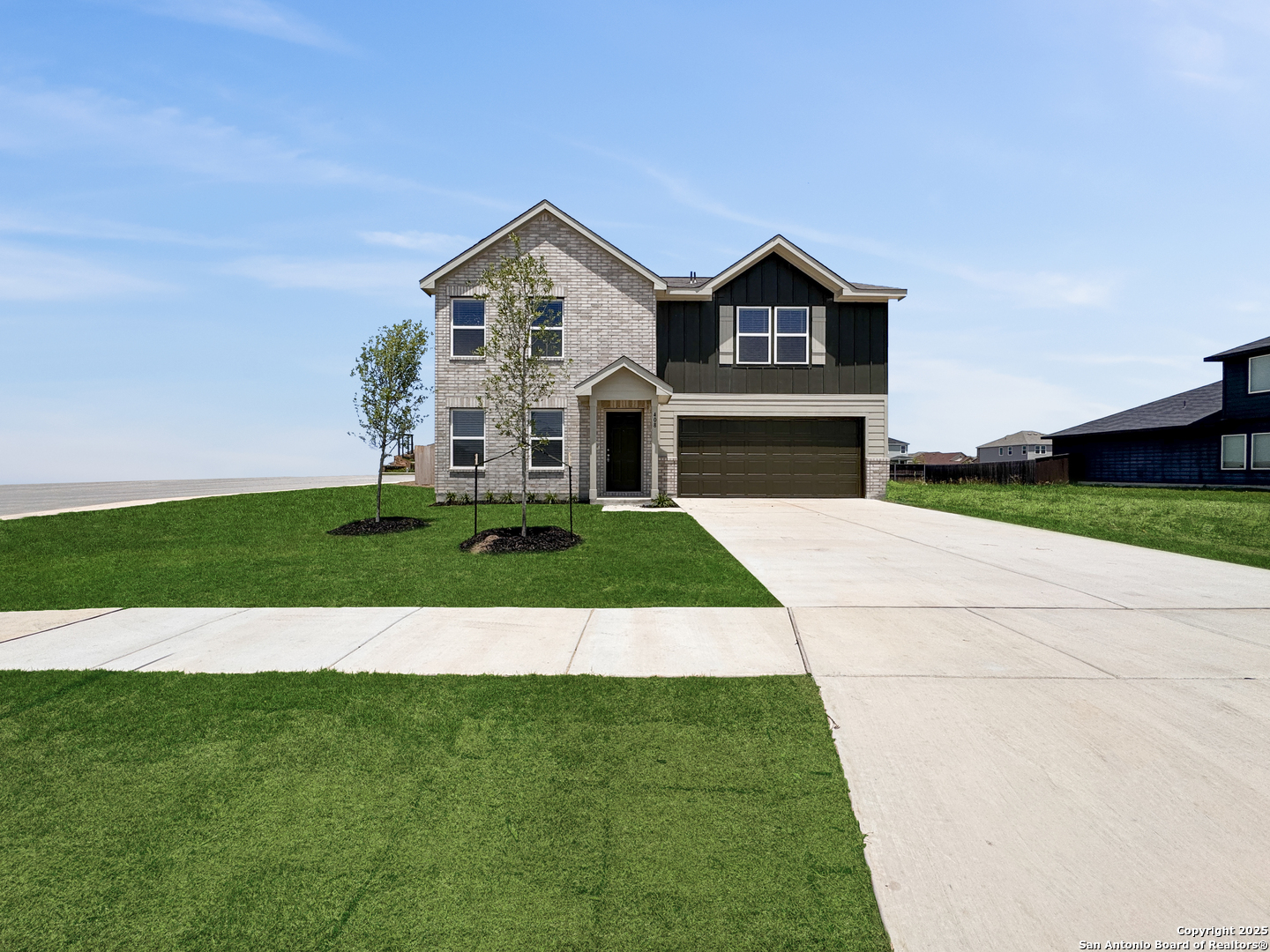 a view of house with garden and tall trees