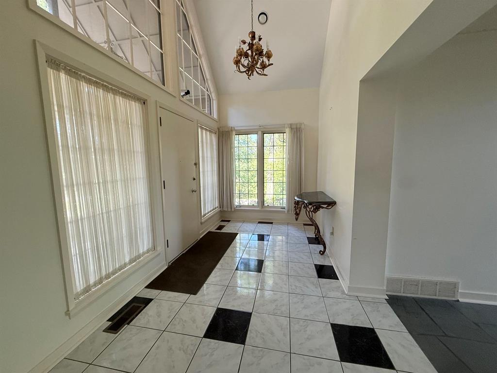 231 Fairview Road Pittsburgh, PA 15238 - Photo 8 of 29 a hallway with a black white checkered floor and a large window