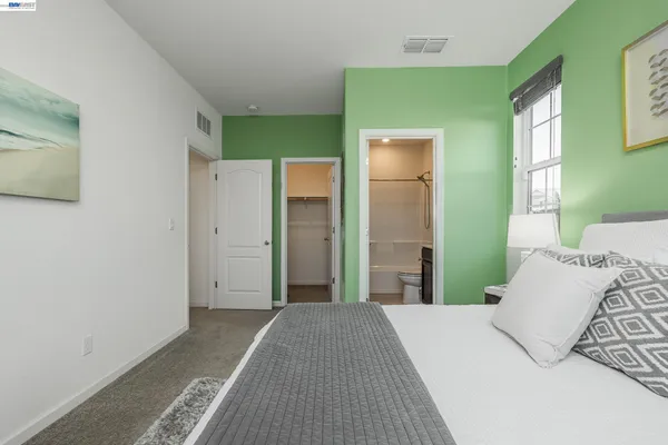 a bedroom with a bed and a mirror