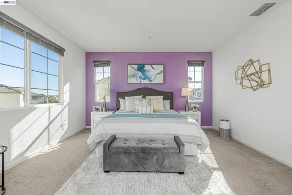 a bedroom with a large bed and a large window