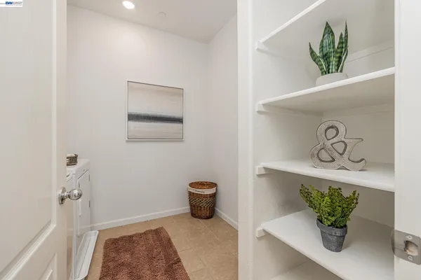 a room with a table chair and a window