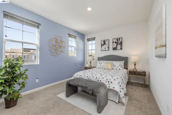 a bedroom with a bed and a potted plant