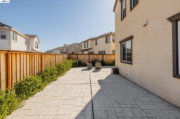 a view of a pathway of a house with wooden floor and fence
