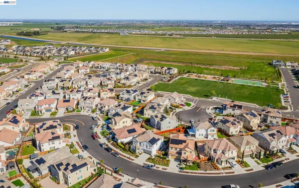 an aerial view of multiple houses with a yard