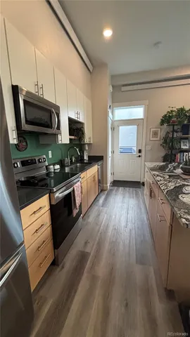 a spacious bedroom with a bed and a dresser