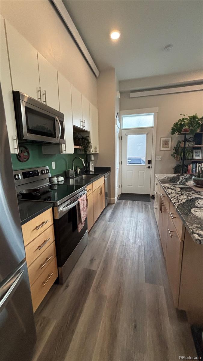116 Old Stage Road, Unit B Salida, CO 81201 - Photo 7 of 20 a kitchen with stainless steel appliances a stove a sink and a refrigerator
