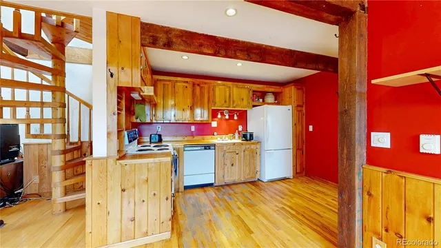 a view of a room with wooden floor and windows