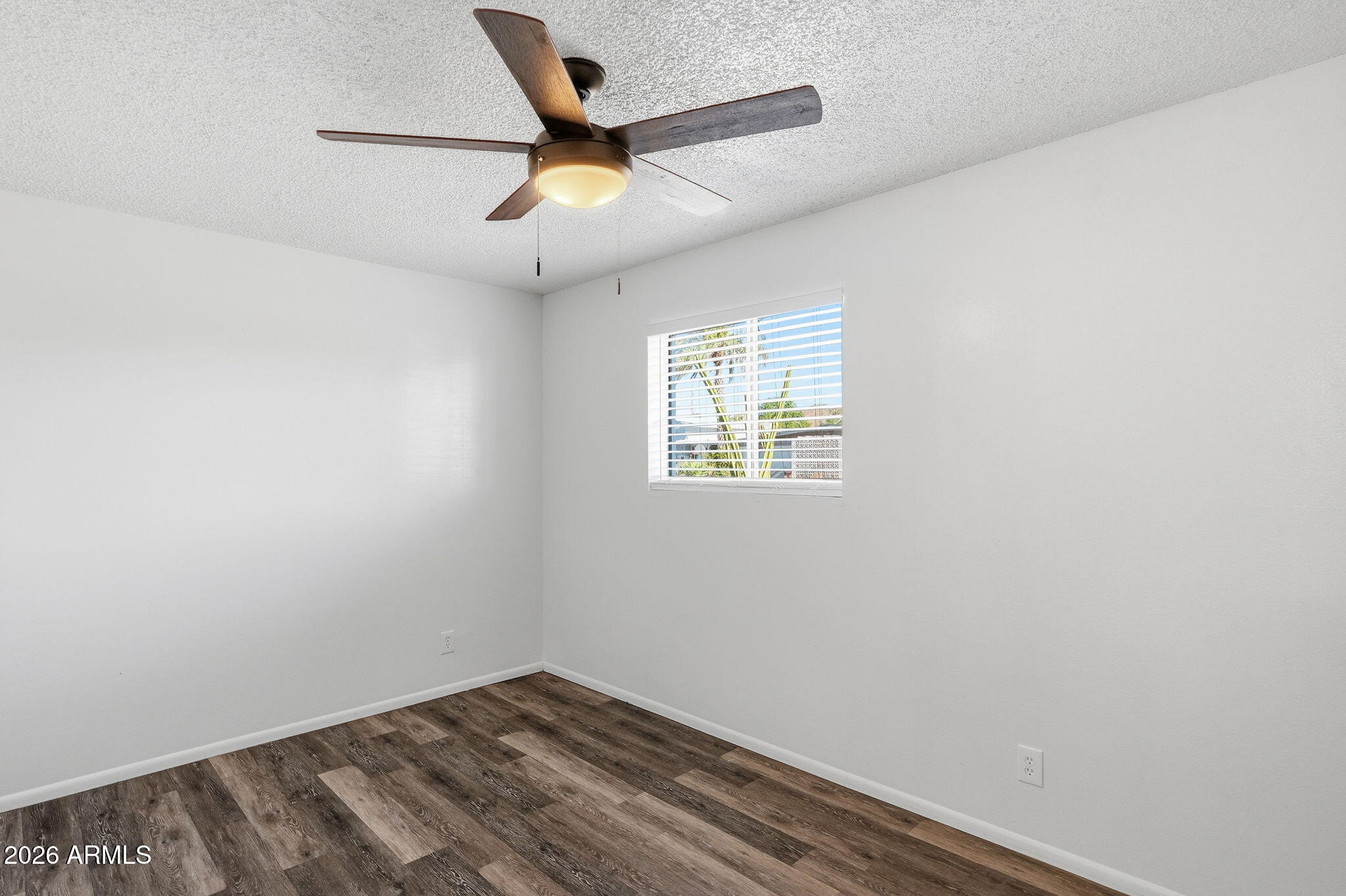 2302 East Nisbet Road Phoenix, AZ 85022 - Photo 15 of 22 an empty room with a window and ceiling fan