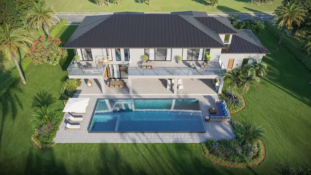 an aerial view of a house with garden space and a patio