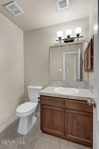 a spacious bathroom with a double vanity sink a mirror and a shower