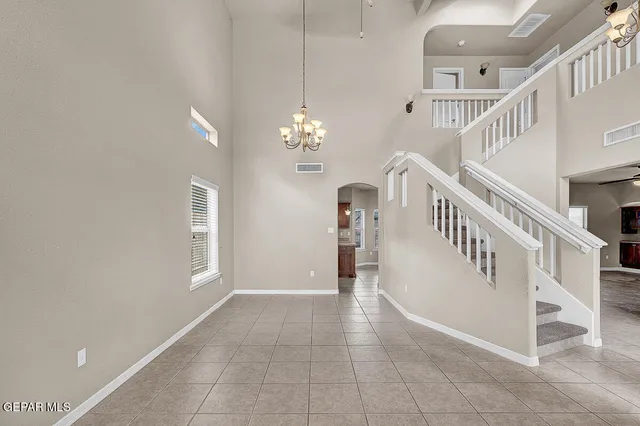 an empty room with windows and entrance