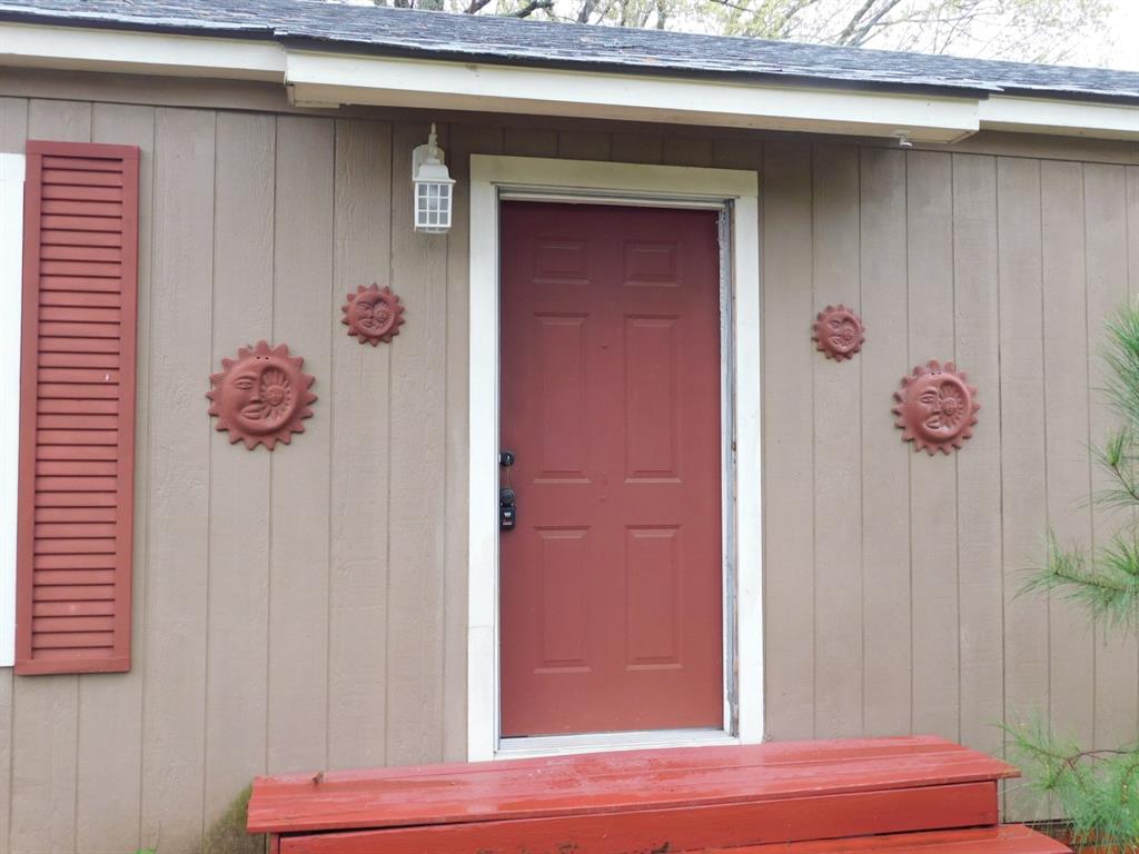 901 North Arkansas Street Springhill, LA 71075 - Photo 13 of 26 Property entrance featuring a shingled roof
