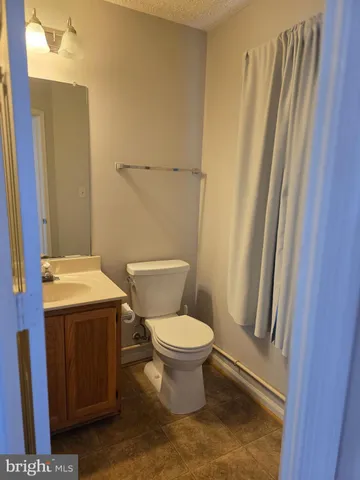 a toilet sitting in a bathroom next to a sink