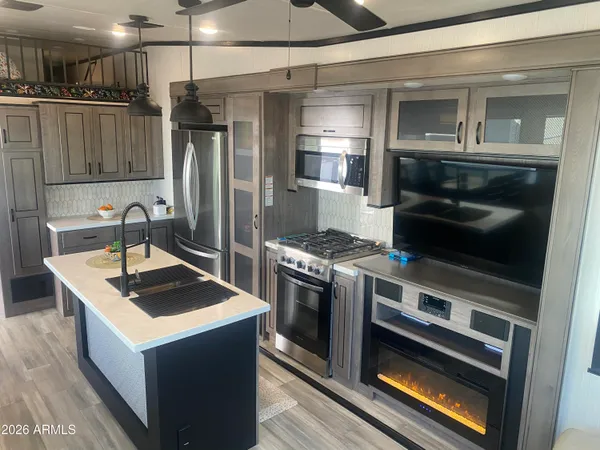 a kitchen with granite countertop a stove and a refrigerator