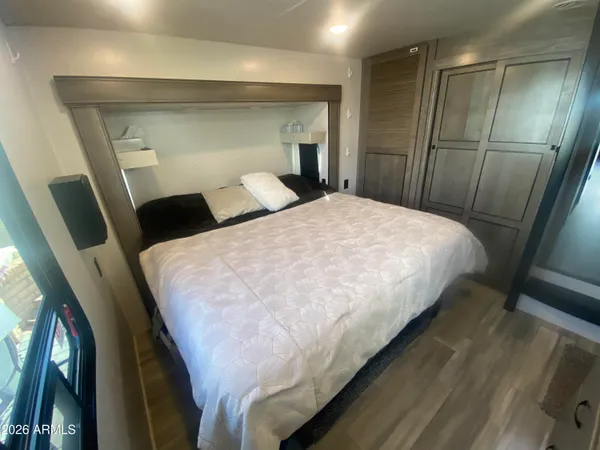 a large bed in a bedroom with a mirror