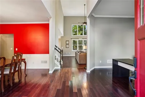 a view of a living room with furniture and wooden floor
