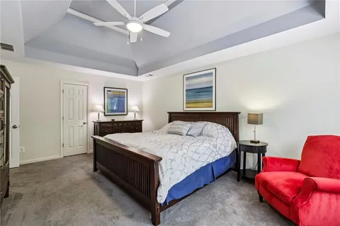 a bedroom with a bed and a couch