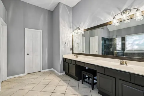 a bathroom with a sink double vanity and a mirror